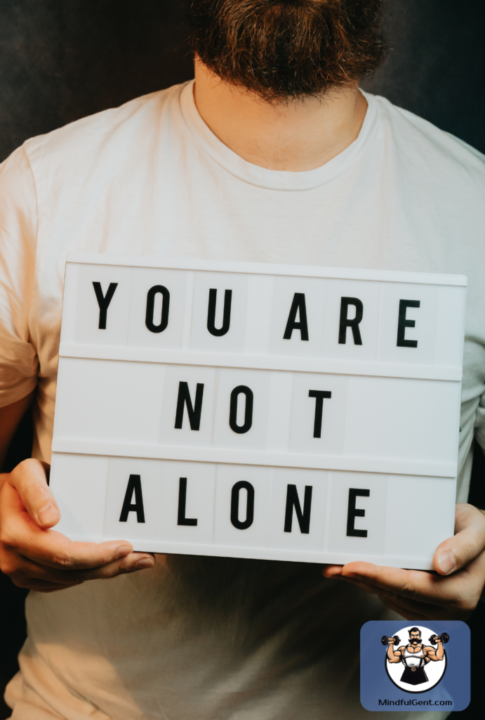 Man holding a sign that says, "You are not alone."